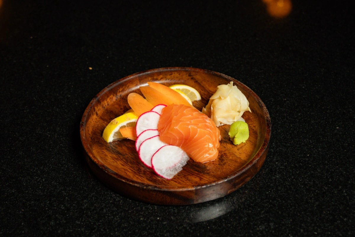 Fresh salmon sashimi served on wooden plate at Mizu
